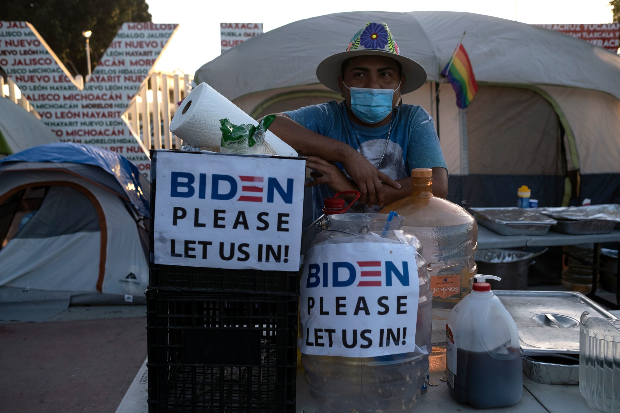 Guatemalan migrant Douglas Marroquin stands near an improvised kitchen covered at a migrant camp outside El Chaparral in Tijuana, Mexico, on February 25, 2021. - Migrants cross through the port hopping to arrive to the United States. (Photo by Guillermo Arias / AFP) (Photo by GUILLERMO ARIAS/AFP via Getty Images)