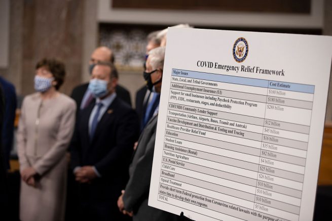 WASHINGTON, DC - DECEMBER 01: A bipartisan group of Democrat and Republican members of Congress as they announce a proposal for a Covid-19 relief bill on Capitol Hill on December 01, 2020 in Washington, DC. The roughly $908 billion proposal includes $288 billion in small business aid such as Paycheck Protection Program loans, $160 billion in state and local government relief and $180 billion to fund a $300 per week supplemental unemployment benefit through March, according to a draft framework. (Photo by Tasos Katopodis/Getty Images)