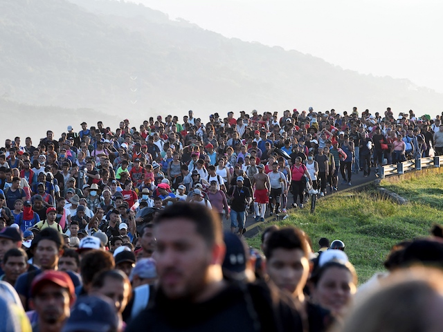 Analysis: VP Kamala Harris Less Popular than Predecessors Pence, Biden, Cheney, and Gore 1 Migrants heading in a caravan to the US, walk towards Mexico City to request asylum and refugee status in Huixtla, Chiapas State, Mexico, on October 27, 2021.(Isaac Guzman/AFP via Getty Images)
