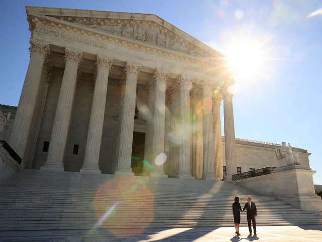 Exclusive-- Pence to Deliver Pro-Life Address as Supremes Mull MS Case: ‘Tragedy’ of Roe Is ‘Unprecedented in the History of Mankind’ 2 WASHINGTON, DC - OCTOBER 01: U.S. Supreme Court Associate Justice Amy Coney Barrett (L) shakes hands with Chief Justice John Roberts on the plaza in front of the west side of the Supreme Court following her investiture ceremony on October 01, 2021 in Washington, DC. Barrett has been a member of the court for more than a year but her investiture ceremony was delayed because of the coronavirus pandemic. (Photo by Chip Somodevilla/Getty Images)