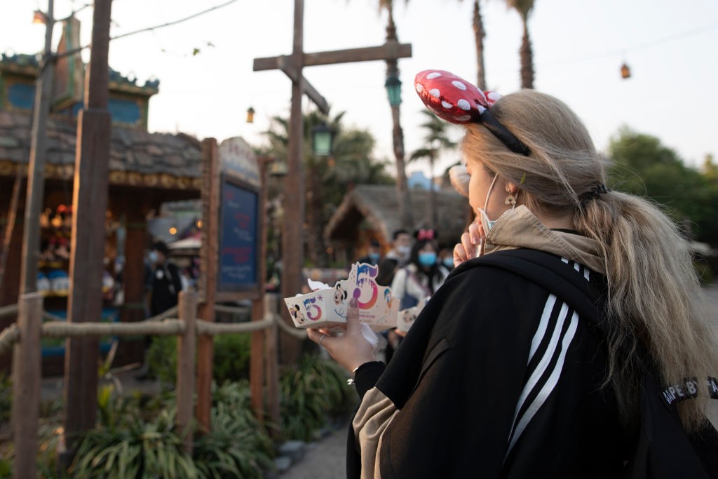 SHANGHAI, CHINA - APRIL 08: A tourist holds a food case with 5th Birthday feature at shanghai disneyland on April 08, 2021 in Shanghai, China. (Photo by Hu Chengwei/Getty Images)