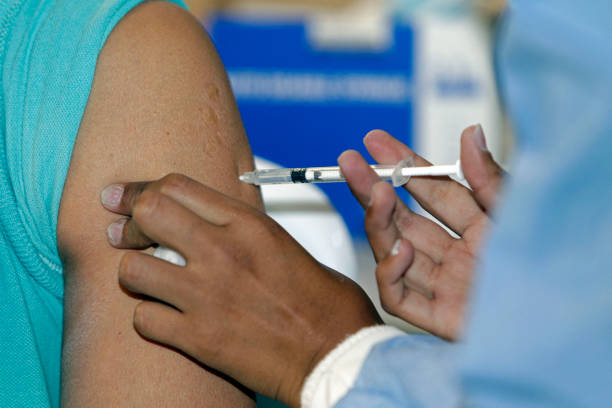 Woman is inoculated with the AstraZeneca/Oxford vaccine against the novel coronavirus disease COVID-19, at a vaccination centre at the Inaquito...