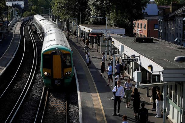 PHOTO: Commuters wait for their train on a platform at West Norwood station in south London, on July 18, 2022, amid disruption warnings over extreme heat. (Niklas Halle'n/AFP via Getty Images)